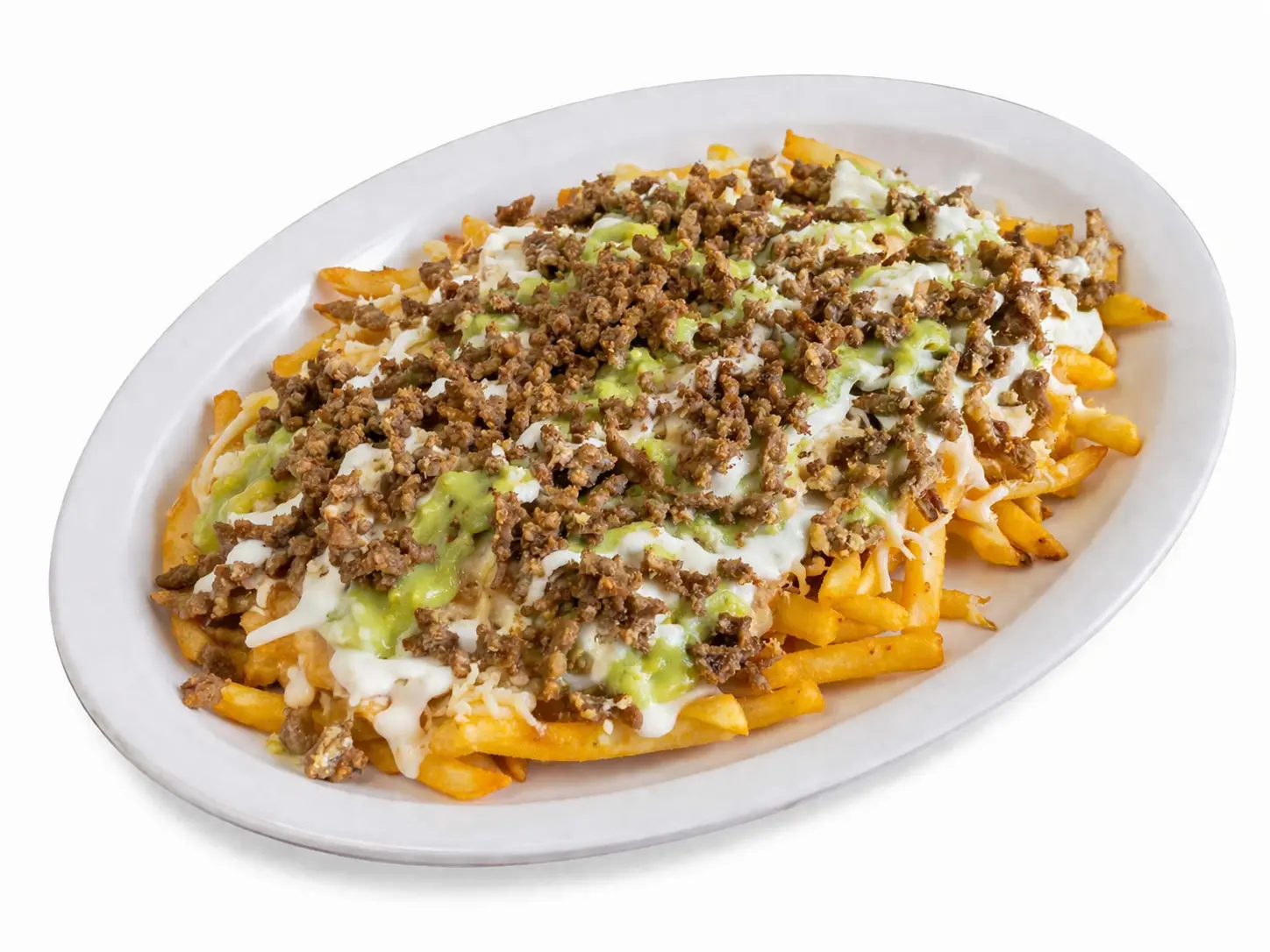 Loaded nachos and fries topped with seasoned meat, cheese, guacamole and sour cream on white plate