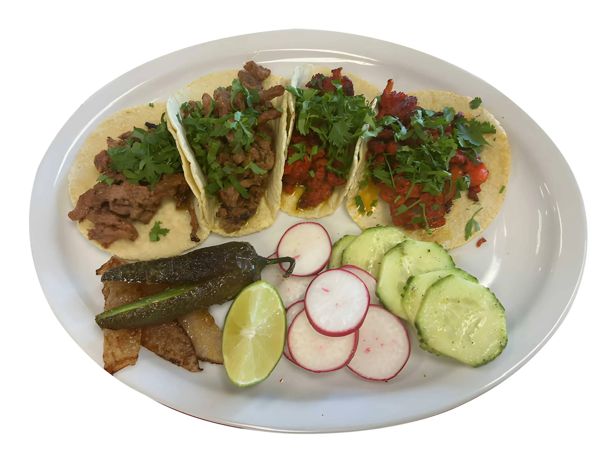 Plate of authentic Mexican tacos with cilantro, meat, radishes, cucumber, and lime